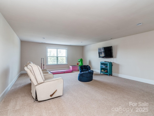 carpeted living room featuring baseboards