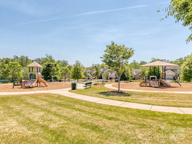 view of home's community featuring a yard and playground community