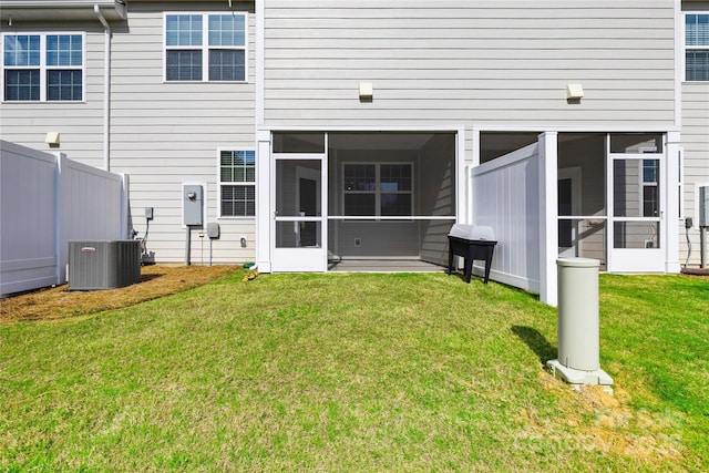 7004 Everly Commons Ln, Tega Cay, SC 29708 - back of house featuring central air condition unit, fence, a yard, and a sunroom