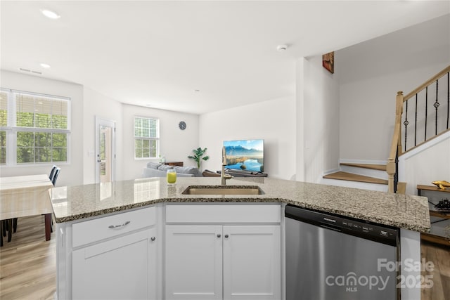 7004 Everly Commons Ln, Tega Cay, SC 29708 - kitchen featuring light wood-style flooring, open floor plan, white cabinetry, light stone counters, and dishwasher