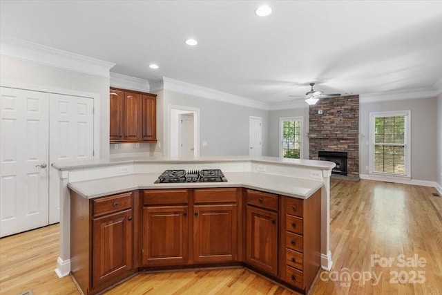 kitchen featuring plenty of natural light, light countertops, black gas cooktop, and ceiling fan