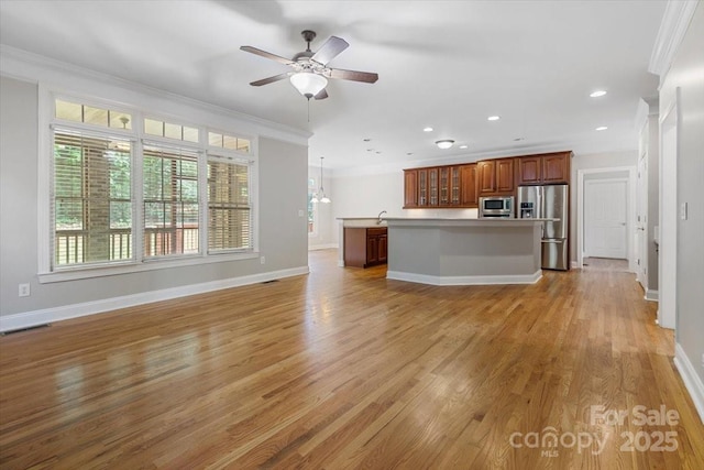 unfurnished living room featuring baseboards, crown molding, visible vents, and light wood-type flooring