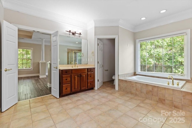 full bath featuring a shower stall, toilet, vanity, crown molding, and a garden tub
