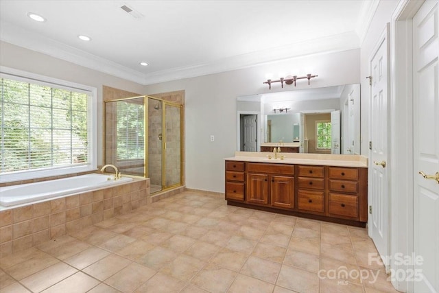 bathroom featuring plenty of natural light, a garden tub, visible vents, and crown molding