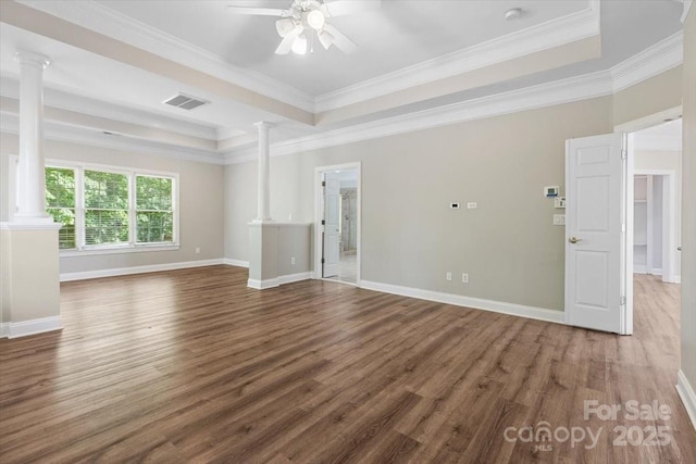 unfurnished living room with wood finished floors, visible vents, and ornate columns