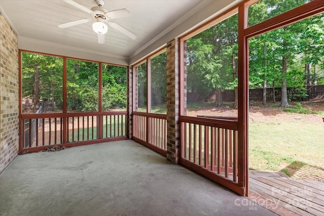 unfurnished sunroom featuring ceiling fan