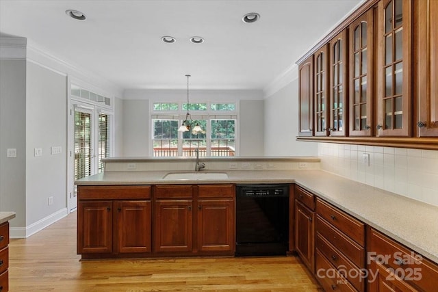 kitchen with a peninsula, light countertops, a sink, glass insert cabinets, and dishwasher