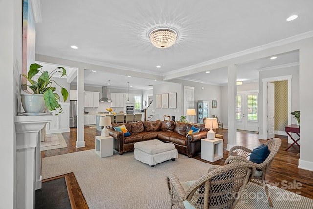 309 Catawba Ave, Davidson, NC 28036 - living room featuring plenty of natural light, dark wood-style floors, baseboards, crown molding, and recessed lighting
