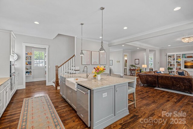 309 Catawba Ave, Davidson, NC 28036 - kitchen featuring a sink, stainless steel appliances, gray cabinetry, a kitchen island with sink, and open floor plan