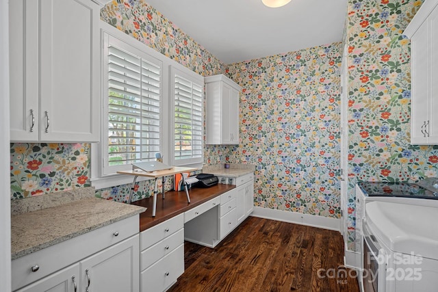 309 Catawba Ave, Davidson, NC 28036 - kitchen with wallpapered walls, washer and dryer, baseboards, dark wood finished floors, and white cabinets