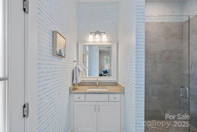 309 Catawba Ave, Davidson, NC 28036 - bathroom with wallpapered walls, vanity, and a stall shower