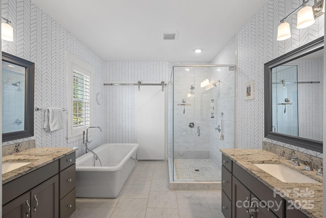 309 Catawba Ave, Davidson, NC 28036 - bathroom with a stall shower, a soaking tub, two vanities, wallpapered walls, and marble look tiles