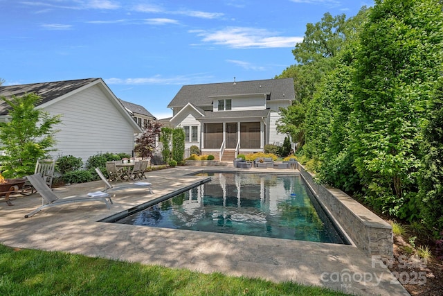 309 Catawba Ave, Davidson, NC 28036 - back of house featuring a sunroom, a patio, and an outdoor pool