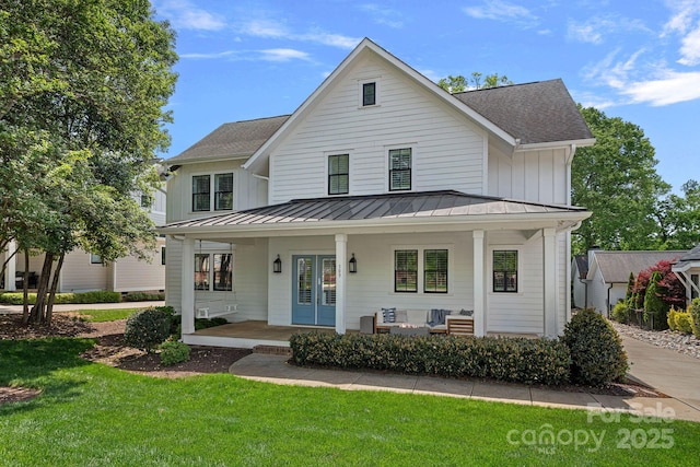 309 Catawba Ave, Davidson, NC 28036 - view of front of house with a standing seam roof, a front yard, and a porch
