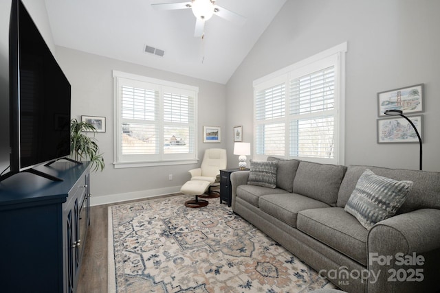 living area with plenty of natural light, wood finished floors, visible vents, and a ceiling fan