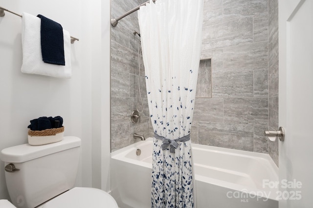 bathroom featuring shower / tub combo and toilet