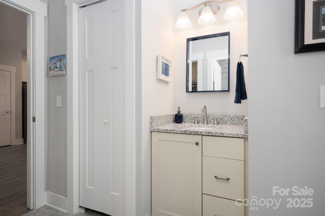 bathroom with baseboards and vanity