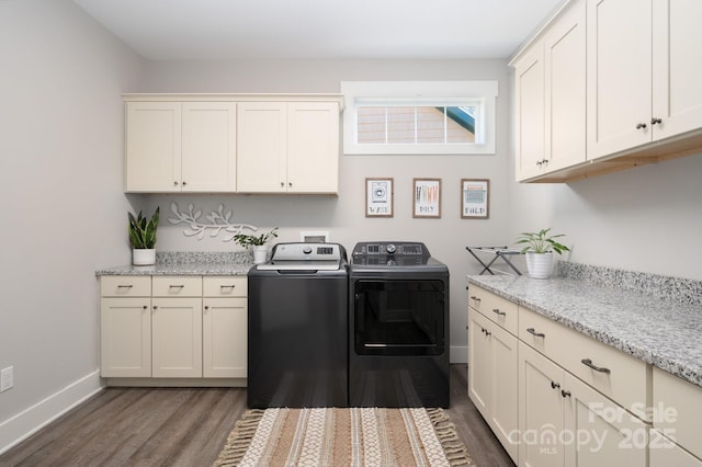 laundry room with dark wood-style flooring, cabinet space, washer and clothes dryer, and baseboards