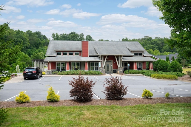 townhome / multi-family property featuring a chimney and uncovered parking