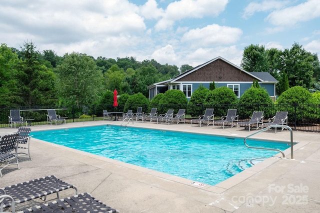 community pool featuring fence and a patio