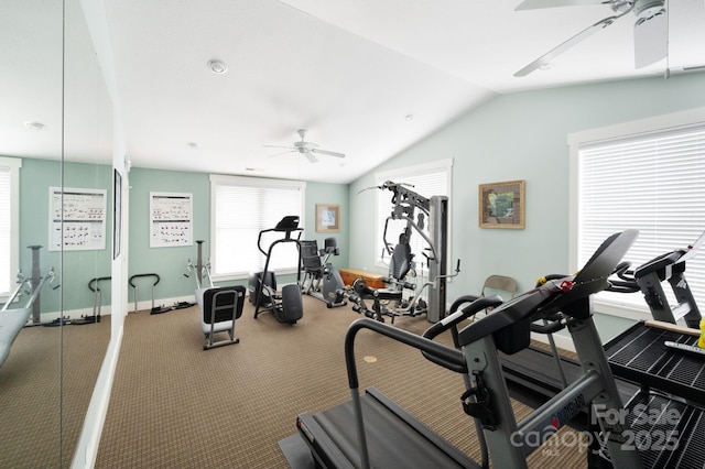 gym featuring baseboards, a ceiling fan, visible vents, and vaulted ceiling