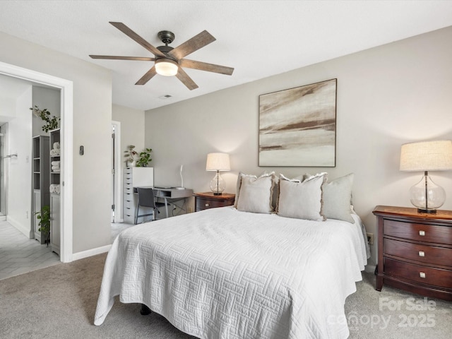 carpeted bedroom with baseboards and a ceiling fan