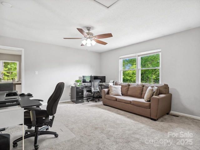 office area with a healthy amount of sunlight, baseboards, and carpet
