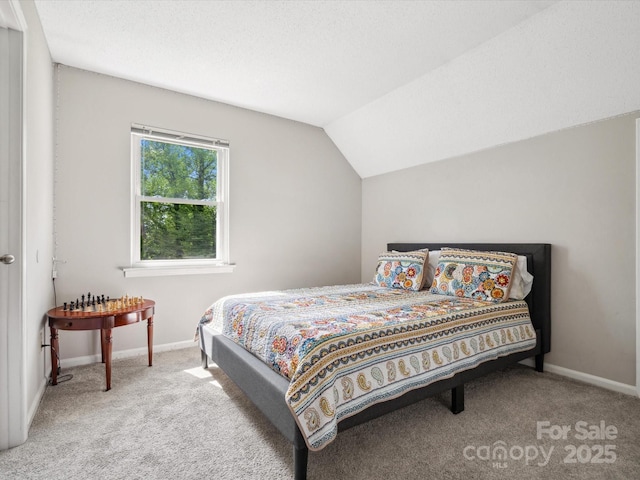 bedroom featuring baseboards, carpet, and lofted ceiling
