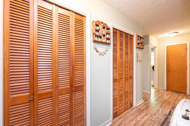 1300 Math Pl, Lenoir, NC 28645 - hallway featuring baseboards, a textured ceiling, and wood finished floors
