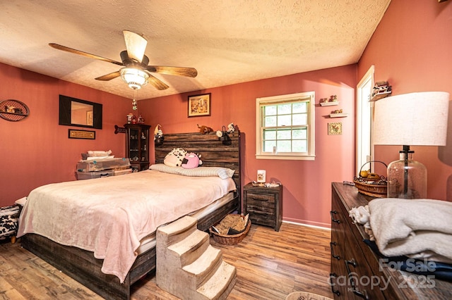 1300 Math Pl, Lenoir, NC 28645 - bedroom with baseboards, a ceiling fan, a textured ceiling, and wood finished floors
