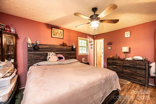 1300 Math Pl, Lenoir, NC 28645 - bedroom with a textured ceiling, ceiling fan, and wood finished floors