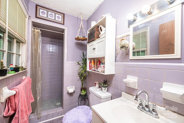 1300 Math Pl, Lenoir, NC 28645 - bathroom featuring vanity, toilet, tile walls, tiled shower, and a textured ceiling