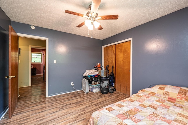 1300 Math Pl, Lenoir, NC 28645 - bedroom featuring a closet, wood finished floors, baseboards, a textured ceiling, and a ceiling fan