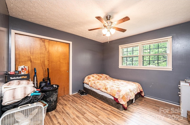 1300 Math Pl, Lenoir, NC 28645 - bedroom featuring a textured ceiling, a ceiling fan, baseboards, wood finished floors, and a closet