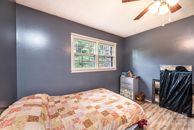 1300 Math Pl, Lenoir, NC 28645 - bedroom featuring a textured ceiling, a ceiling fan, and wood finished floors
