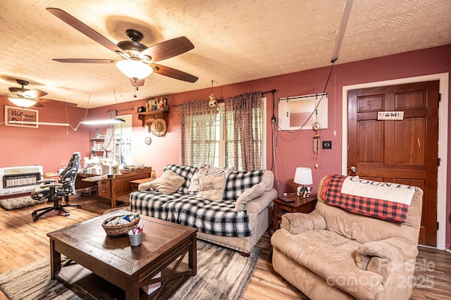 1300 Math Pl, Lenoir, NC 28645 - living room featuring heating unit, a textured ceiling, and wood finished floors