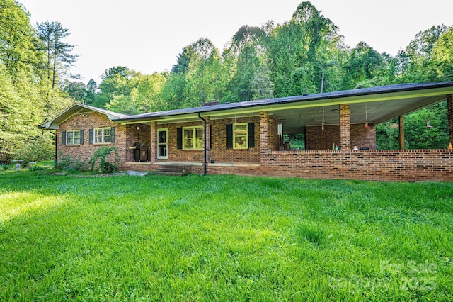 1300 Math Pl, Lenoir, NC 28645 - rear view of property with covered porch, a yard, and brick siding