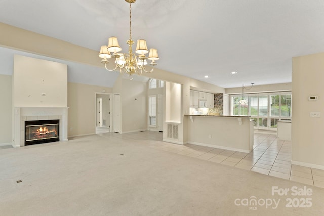111 Broadmoor Dr, Flat Rock, NC 28731 - unfurnished living room with baseboards, light tile patterned flooring, light carpet, a fireplace, and a notable chandelier