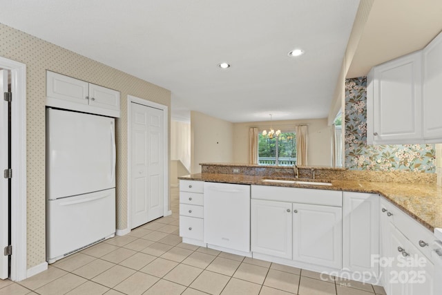 111 Broadmoor Dr, Flat Rock, NC 28731 - kitchen with a sink, a peninsula, white cabinetry, white appliances, and wallpapered walls
