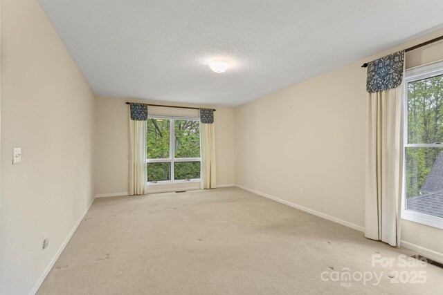 111 Broadmoor Dr, Flat Rock, NC 28731 - unfurnished room with a textured ceiling, carpet flooring, visible vents, and baseboards
