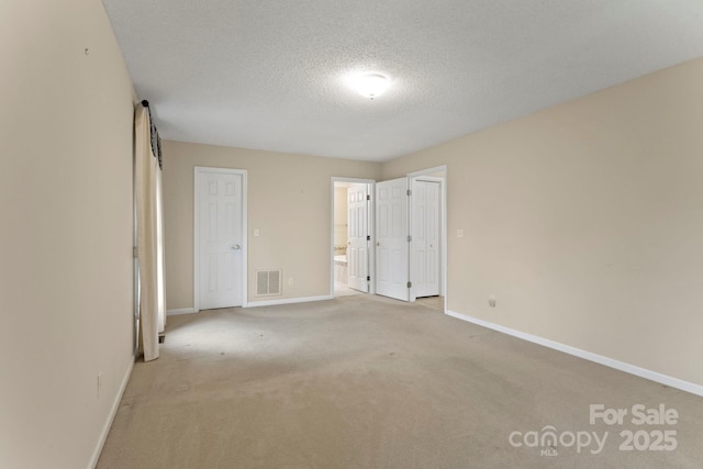 111 Broadmoor Dr, Flat Rock, NC 28731 - unfurnished bedroom featuring carpet flooring, a textured ceiling, visible vents, and baseboards