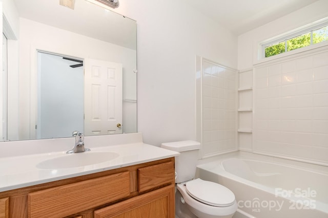 bathroom with toilet, vanity, and  shower combination