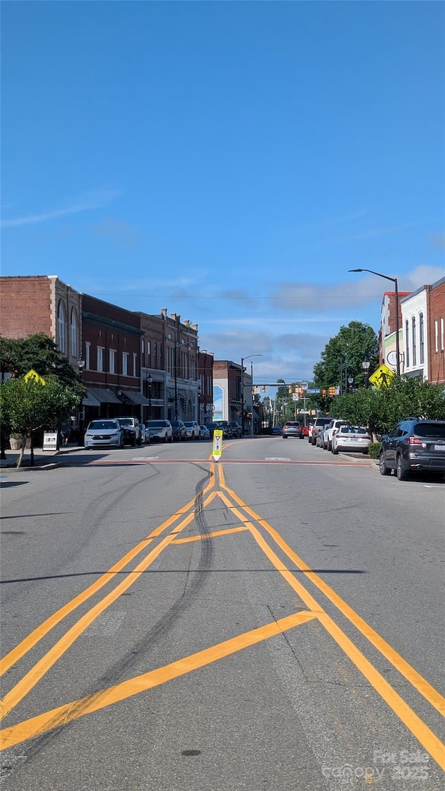 110 Canary Ln Unit 3, Mooresville, NC 28115 - view of asphalt road with street lighting, sidewalks, curbs, traffic lights, and traffic signs