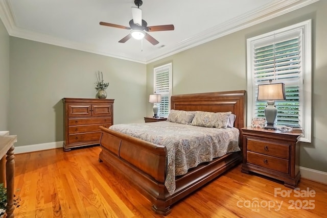 bedroom featuring light wood finished floors, multiple windows, and baseboards