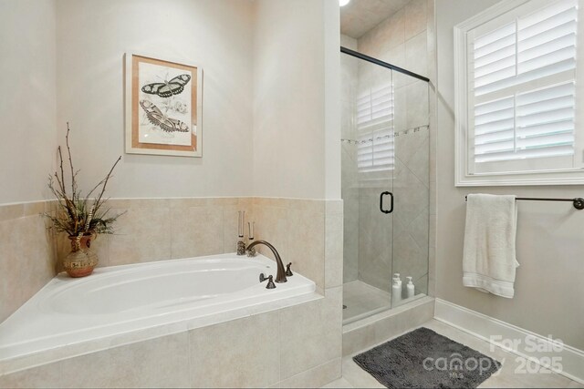 bathroom with a bath and a shower stall
