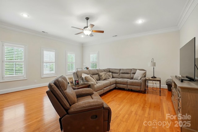 living area with light wood finished floors, a ceiling fan, and plenty of natural light