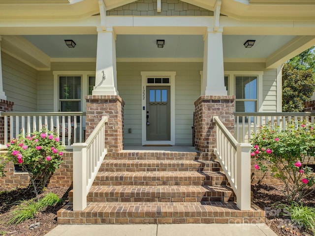 entrance to property featuring a porch