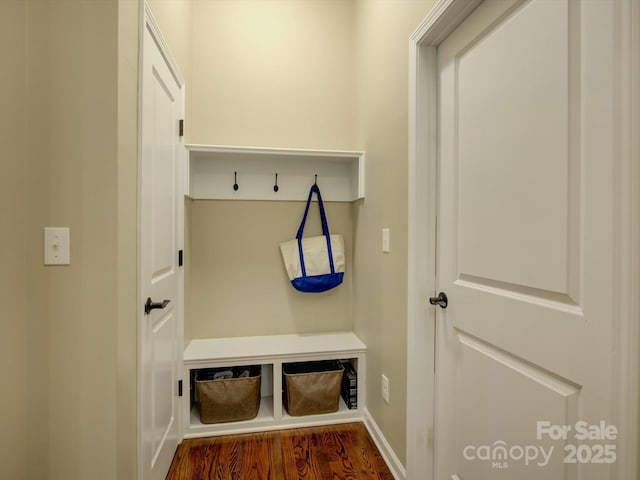 mudroom with dark wood-type flooring and baseboards