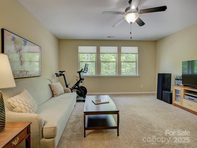living room featuring visible vents, a ceiling fan, baseboards, and carpet flooring