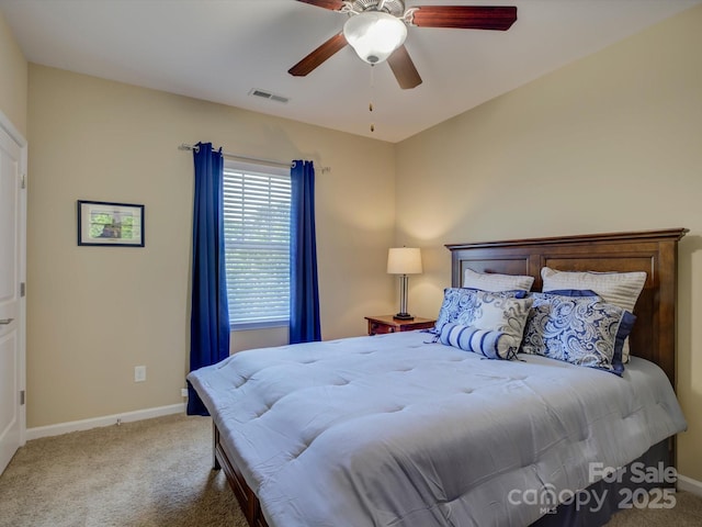 carpeted bedroom featuring a ceiling fan, baseboards, and visible vents